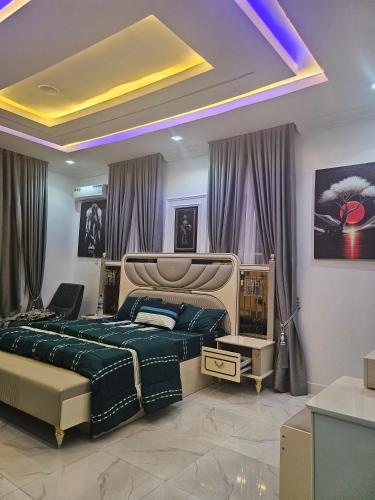 a bedroom with a large bed and purple curtains at luxury 3bed rooms duplex lekki Lagos nigeria in Lekki