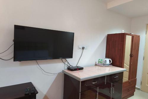 a flat screen tv hanging on a wall at Darul Salam Inn in Kertih