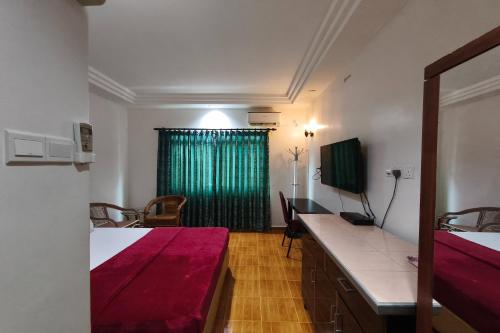 a bedroom with two beds and a green curtain at Darul Salam Inn in Kertih