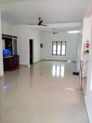 an empty room with a white floor and a ceiling at Farah Homestay in Varkala