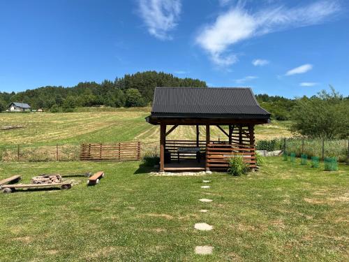 a cabin in the middle of a field at Domek u Gołąbków Bieszczady in Lesko