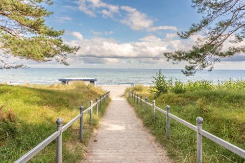 a path leading to a beach with the ocean at Villa Strandidyll Neubau Ferienwohnung 1 2 mit Balkon in Binz