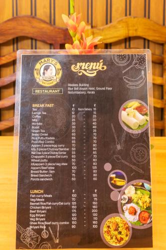 a menu for a restaurant with food on a table at Stella Marries Airpot Lounge in Nedumbassery