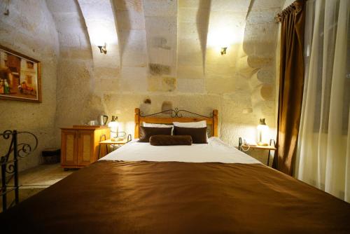 a bedroom with a large bed in a room at Harman Cave Hotel in Goreme