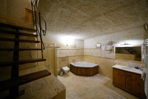 a bathroom with a tub and a toilet and a sink at Harman Cave Hotel in Goreme