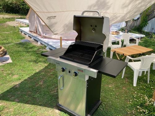 a grill with a laptop on it with a tent at ザビーチ in Wada