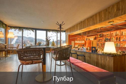 a bar with chairs and a counter in a room at Fomich Residence in Bukovel