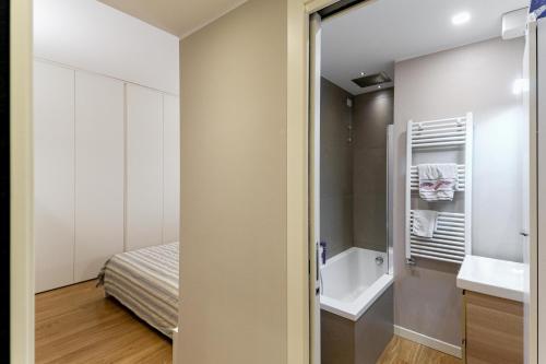 a small bathroom with a sink and a bed at Milan nanna B&B, metro M3,IEO, Duomo COLAZIONE INCLUSA in San Donato Milanese