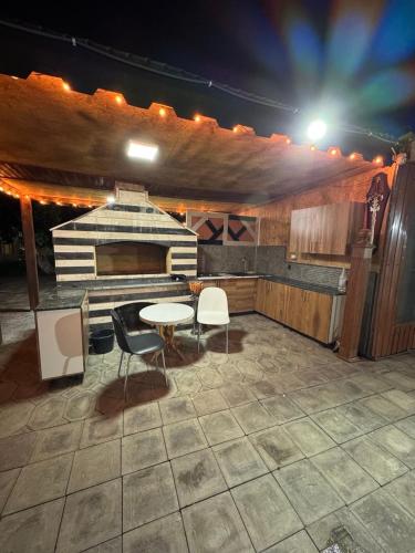 a patio with a table and chairs and a stove at Hovakimyans Garden And Pool in Zvartnots International Airport