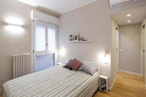 a bedroom with a bed and a window at Milan nanna B&B, metro M3,IEO, Duomo COLAZIONE INCLUSA in San Donato Milanese