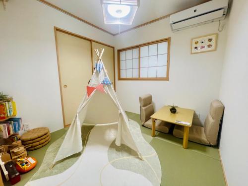 a room with a dress hanging from the ceiling at Naha Airport, beaches, shopping centers are nearby #NewVilla in Itoman