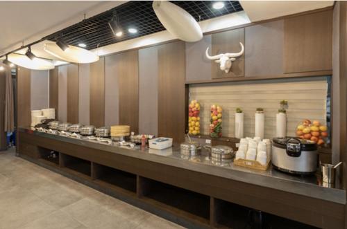 a buffet line in a restaurant with food at With Stay Jeju Hotel in Jeju