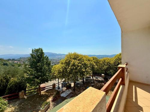 a balcony of a house with a view of trees at Hotel Horizont in Kuçovë