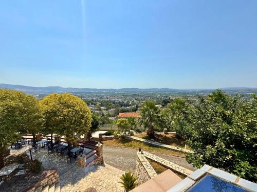 a villa with a pool and a view of the city at Hotel Horizont in Kuçovë
