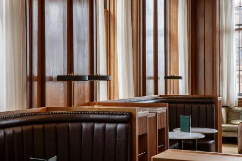 a waiting room with two benches and a table at The Edinburgh Grand, a Luxury Collection Hotel, Edinburgh in Edinburgh