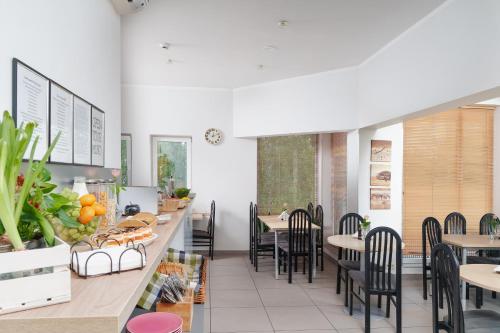 a restaurant with tables and chairs and a counter at Arcus Premium Hostel in Warsaw