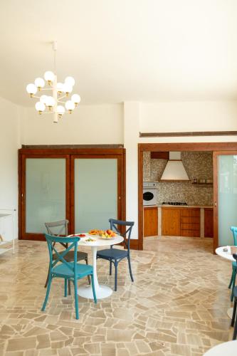 a dining room with a table and chairs at Castellinaria Holiday in Castellana Grotte