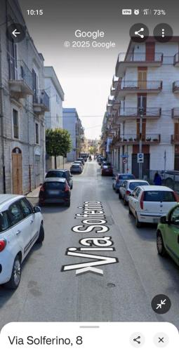 a street with cars parked on the side of the road at La casa di Mina in Ruvo di Puglia