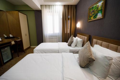 Ένα ή περισσότερα κρεβάτια σε δωμάτιο στο Royal Meridien Hotel