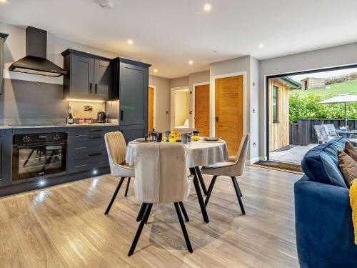 a kitchen and dining room with a table and chairs at 2 Bed in Heyope 94202 in Knighton