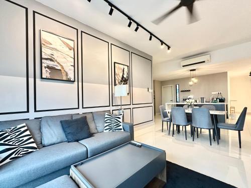 a living room with a couch and a dining room at Mid Valley Southkey Mosaic 3BR with WIFI 8-10 pax in Johor Bahru