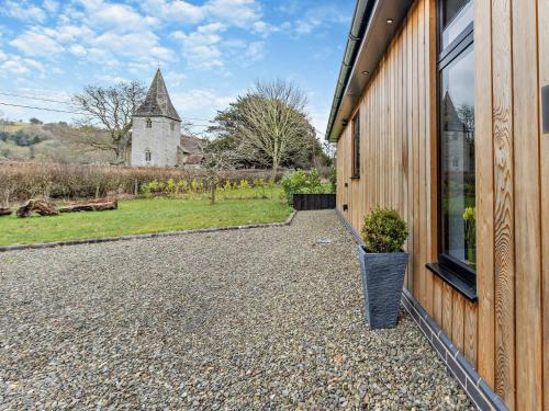 a building with a window and a church in the background at 2 Bed in Heyope 94202 in Knighton