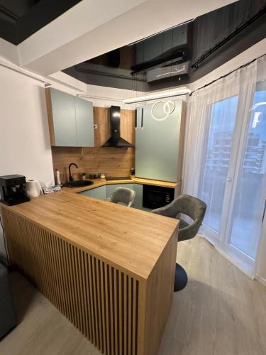 a kitchen with a wooden counter top in a room at MPR Seaview in Năvodari