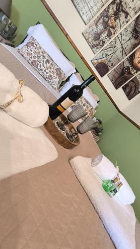 a bottle of wine sitting on a bed with towels at Sofilia view house in Argilia