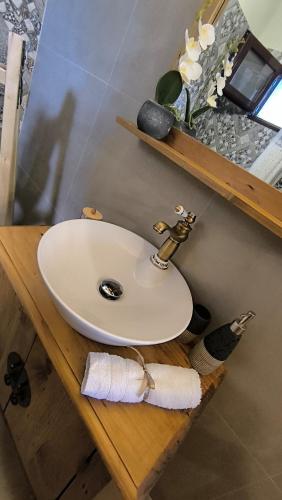 a white sink on a wooden counter in a bathroom at Sofilia view house in Argilia