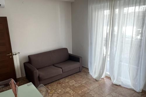 a living room with a couch and a window at Apollo in Arma di Taggia