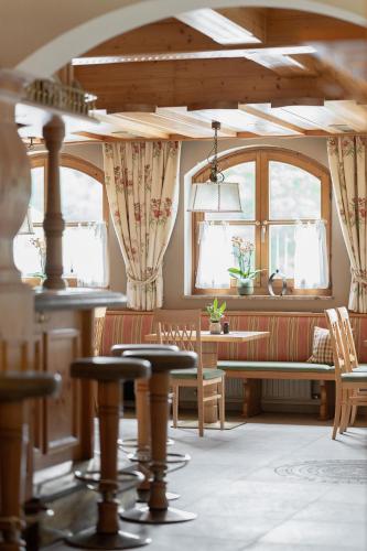 a living room with a couch and a table at ARBOR Hotel & Apartments in Saalbach Hinterglemm