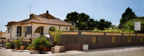 a house with a fence in front of it at B&B Il Mandorlo in Sciacca