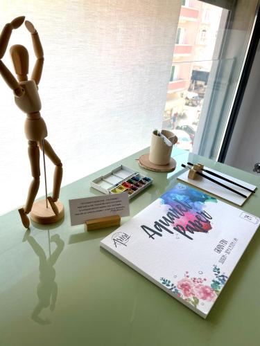 a desk with a figurine and a book on a table at Suíte Campo de Ourique - Art and Comfort in Lisbon