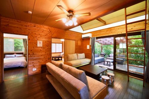 a living room with a couch and a bed at アシェル那須 in Nasu
