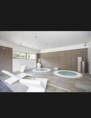 a living room with three circular tables and chairs at Studio Pont du Gard in Remoulins