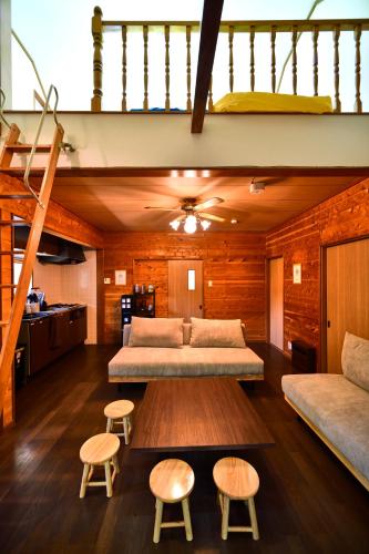 a bedroom with a bed and two stools at Ashel Nasu in Nasu
