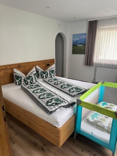 a bedroom with two beds and a chair at Martinshof Ladis in Ladis