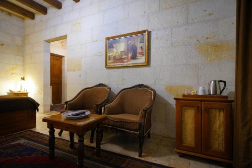 a living room with two chairs and a table at Harman Cave Hotel in Goreme