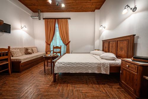 a bedroom with a bed and a couch at Heliodora in Kissós