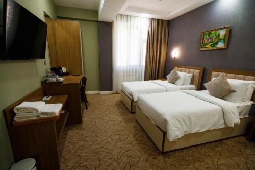 Ένα ή περισσότερα κρεβάτια σε δωμάτιο στο Royal Meridien Hotel