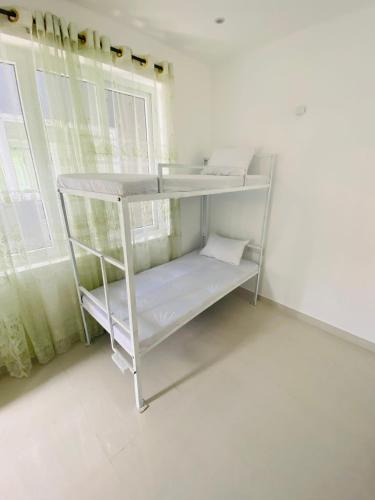 a white shelf in a room with a window at Truly Hostel Kandy in Kandy