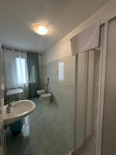 a bathroom with a sink and a toilet at Hotel Ginevra e Residence in Cattolica