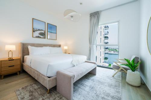 a bedroom with a bed and a large window at One Bedroom Apartment by Otolo Homes with Free Yas Theme Park Tickets in Abu Dhabi