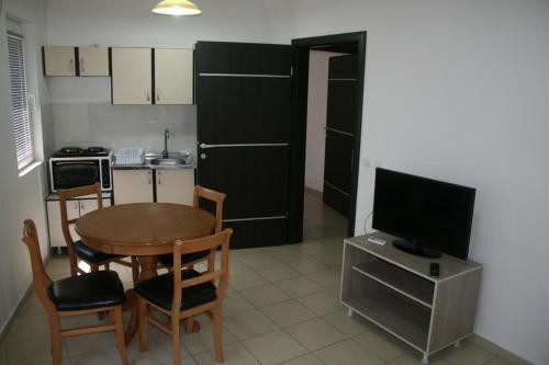 a small kitchen with a table and a television at Villa Zora in Star Dojran