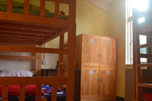 a bedroom with two bunk beds and a closet at Notting Hill Hostel in Bao'an