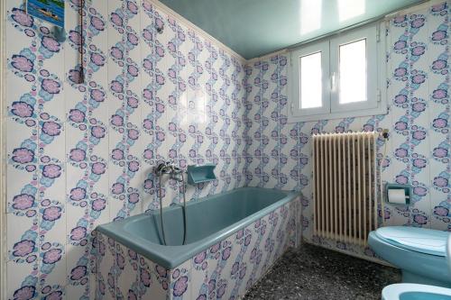 a bathroom with a bath tub and a toilet at Retro 2-Bdrm House Near Metro in Heraklion by ΜΡS in Athens