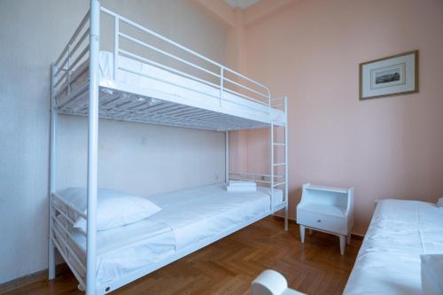 a bedroom with two bunk beds in a room at Retro 2-Bdrm House Near Metro in Heraklion by ΜΡS in Athens