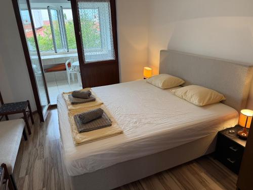 a bedroom with a bed with a tray on it at Ogi Seaside Gajac in Novalja