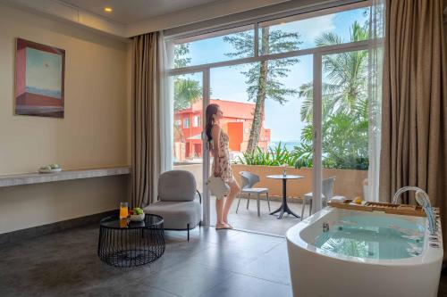 a woman standing in a living room with a tub at Shenzhen Maancoco Seaview Villa Jiaochangwei Coastline in Dapeng