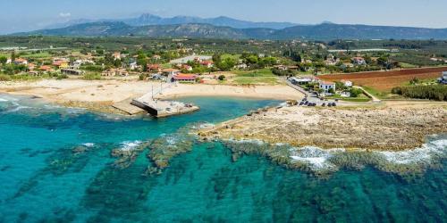an aerial view of a beach with a boat in the water at Seaview and Sunsets - Beachside Retreats in Ayía Kiriakí